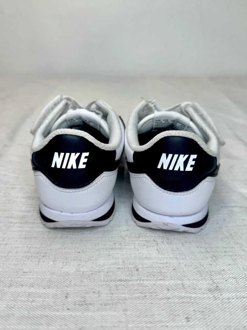 Nike Kids White Sneakers with Black Swoosh